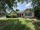 Charming single-story home with a well-manicured lawn, featuring a classic facade and inviting front entrance at 1855 Tribble Ridge Dr, Lawrenceville, GA 30045
