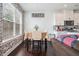 Bright dining area features an exposed brick wall, hardwood floors, and dining table seating four at 211 N Auburn Landing Pl, Auburn, GA 30011