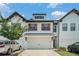 Delightful townhome showcases a convenient two-car garage, accented by wood shutters, creating an inviting curb appeal at 211 N Auburn Landing Pl, Auburn, GA 30011