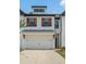 Charming townhome featuring a two-car garage, warm wood shutters, and a beautifully painted white brick facade at 211 N Auburn Landing Pl, Auburn, GA 30011