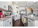 Modern kitchen features white cabinets, granite countertops, stainless steel appliances, and a pantry at 211 N Auburn Landing Pl, Auburn, GA 30011