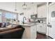 Modern kitchen featuring granite countertops, sleek white cabinets, and stainless steel appliances at 211 N Auburn Landing Pl, Auburn, GA 30011