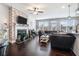 Open-concept living room boasting a cozy fireplace, brick accent wall, and abundant natural light at 211 N Auburn Landing Pl, Auburn, GA 30011