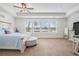 Spacious main bedroom features a tray ceiling, neutral carpet, plenty of natural light, and nice furniture at 211 N Auburn Landing Pl, Auburn, GA 30011