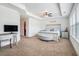 Spacious main bedroom features a tray ceiling, neutral carpet, plenty of natural light, and nice furniture at 211 N Auburn Landing Pl, Auburn, GA 30011