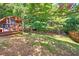 Lush backyard with shady tiki bar, offering a private and tranquil escape in a natural setting at 29 Sedgefield Overlook, Dallas, GA 30157