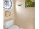 Cozy half bathroom featuring decorative stained glass window, artwork, and neutral wall paint at 29 Sedgefield Overlook, Dallas, GA 30157