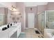 Bathroom featuring double vanity, walk-in shower, and bathtub at 29 Sedgefield Overlook, Dallas, GA 30157
