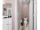 Powder room adjacent to a bathroom featuring a toilet, wall decor, and tile flooring at 29 Sedgefield Overlook, Dallas, GA 30157