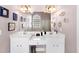 Bathroom featuring double vanity with white cabinets, framed mirrors, and walk-in shower at 29 Sedgefield Overlook, Dallas, GA 30157