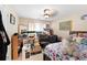 Cluttered bedroom featuring a patterned bedspread, a decorative mirror, and a variety of storage boxes and clothing racks at 29 Sedgefield Overlook, Dallas, GA 30157