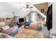 Cozy bedroom with a sloped ceiling, ceiling fan, soft lighting, and an eclectic mix of decorative items and wall hangings at 29 Sedgefield Overlook, Dallas, GA 30157