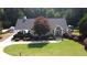 Community clubhouse with well-manicured lawn, attractive landscaping, and patio seating at 29 Sedgefield Overlook, Dallas, GA 30157