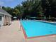 Enjoy the community pool with sun loungers, umbrellas, and lush green surroundings on a sunny day at 29 Sedgefield Overlook, Dallas, GA 30157
