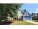 Beautiful two-story home featuring blue siding, stone accents, a manicured lawn, and an attached garage at 29 Sedgefield Overlook, Dallas, GA 30157