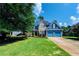 Inviting blue two-story home with stone accents, a well-manicured lawn, and an attached two-car garage at 29 Sedgefield Overlook, Dallas, GA 30157