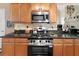 Kitchen featuring stainless steel gas range, granite countertops, and light wood cabinets at 29 Sedgefield Overlook, Dallas, GA 30157