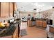 Open-concept kitchen with stainless steel appliances, hardwood floors, and bar seating at 29 Sedgefield Overlook, Dallas, GA 30157