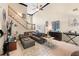 Open-concept living area featuring a staircase, neutral paint, and a comfortable seating arrangement at 29 Sedgefield Overlook, Dallas, GA 30157