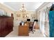 Bright home office featuring a wooden desk, a chandelier, and lots of natural light at 29 Sedgefield Overlook, Dallas, GA 30157