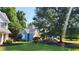 Inviting blue home with a well-kept lawn, mature trees, and attractive landscaping at 29 Sedgefield Overlook, Dallas, GA 30157