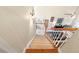 Bright staircase with carpet runner leading to a living room with a vaulted ceiling and many decor items at 29 Sedgefield Overlook, Dallas, GA 30157
