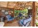 Charming tiki bar on a wooden deck, featuring a rustic thatch roof, comfortable seating, and a shaded outdoor retreat at 29 Sedgefield Overlook, Dallas, GA 30157