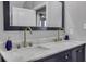 Bathroom featuring double sinks with marble countertops and updated fixtures at 325 E Paces Ferry Ne Rd # 1910, Atlanta, GA 30305