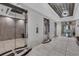 Elevator lobby featuring mirrored doors, tiled floors, and a modern ceiling design for a luxurious experience at 325 E Paces Ferry Ne Rd # 1910, Atlanta, GA 30305