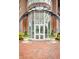 Grand building entrance featuring a circular glass facade, brick accents, and manicured landscaping at 325 E Paces Ferry Ne Rd # 1910, Atlanta, GA 30305
