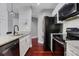 Contemporary kitchen with granite counters, stainless steel appliances, white cabinets, and dark hardwood floors at 325 E Paces Ferry Ne Rd # 1910, Atlanta, GA 30305