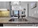 Modern kitchen featuring granite countertops, a stainless steel sink, and views of the stylish living area at 325 E Paces Ferry Ne Rd # 1910, Atlanta, GA 30305