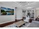 Bright living room with a large screen TV, modern decor, and hardwood floors, creating a comfortable space at 325 E Paces Ferry Ne Rd # 1910, Atlanta, GA 30305
