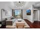 Spacious living room with hardwood floors, modern lighting, a balcony, and views of the city skyline at 325 E Paces Ferry Ne Rd # 1910, Atlanta, GA 30305