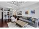 Well-lit living room featuring dark hardwood floors, stylish decor, and an open view to the kitchen and dining area at 325 E Paces Ferry Ne Rd # 1910, Atlanta, GA 30305