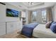 Bright main bedroom with a TV, built-in cabinets, and natural light at 325 E Paces Ferry Ne Rd # 1910, Atlanta, GA 30305
