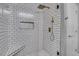 Elegant shower with white subway tile, gold fixtures, and a built-in niche at 325 E Paces Ferry Ne Rd # 1910, Atlanta, GA 30305