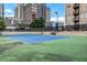 Well-maintained tennis court with a new-looking blue surface and surrounded by a city skyline at 325 E Paces Ferry Ne Rd # 1910, Atlanta, GA 30305