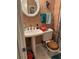 Compact peach tone bathroom featuring pedestal sink and patterned shower curtain at 3090 Alberta Dr, Marietta, GA 30062