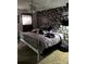 Floral accent wall bedroom with a decorative metal bed and dark curtains at 3090 Alberta Dr, Marietta, GA 30062