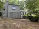 Two-story home featuring neutral siding, a lattice privacy screen and partially wooded front yard at 3090 Alberta Dr, Marietta, GA 30062