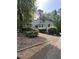 View of the home from the driveway shows the siding, unique roofline and mature trees at 3090 Alberta Dr, Marietta, GA 30062