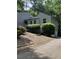 Exterior home view from the driveway shows the gray siding, unique roofline and garage at 3090 Alberta Dr, Marietta, GA 30062