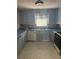 Bright kitchen with blue cabinets, backsplash and white appliances at 3090 Alberta Dr, Marietta, GA 30062