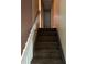 Carpeted stairway leading to an upstairs landing, perfect for storage at 3090 Alberta Dr, Marietta, GA 30062