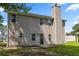 Backyard view of the home with neutral siding and a small patio at 3405 Summer Brooke Way, Union City, GA 30291