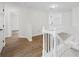 Upstairs hallway featuring hardwood floors, white railing, and an open view at 3405 Summer Brooke Way, Union City, GA 30291