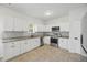 Contemporary kitchen boasting white cabinets, granite countertops, and stainless steel appliances at 3405 Summer Brooke Way, Union City, GA 30291