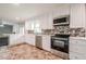 Modern kitchen with stainless steel appliances, white cabinets, and a mosaic backsplash at 4935 Golden Sw Cir, Mableton, GA 30126