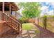 Backyard featuring brick walls, green grass, stone pavers, and wooden stairs at 694 Peeples Sw St, Atlanta, GA 30310